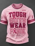 A man wore pink to support his loved one, wearing a printed crew neck top.