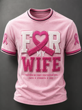 A man wore pink to support his loved one, wearing a printed crew neck top.